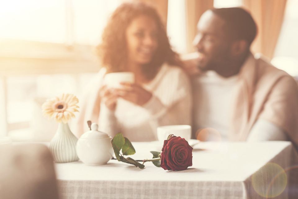 an interracial couple having coffee